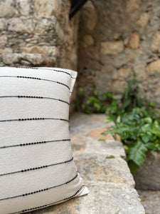 Natural 100% cotton handmade throw pillow with a staccato black stripe pattern woven throughout. Handmade in Oaxaca, Mexico.  