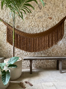 Gold hammock with woven fringe in Yucatan villa.