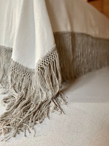 Detailed gray putty fringe on a handmade bedcover