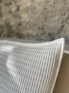 Texture and detial on a handwoven cream colored pillow. Made in Oaxaca Mexico.