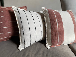 Collection of striped pillows in natural off whote cotton with terracotta and black striped pattern. Handmade throw pillows from Oaxaca, Mexico. 