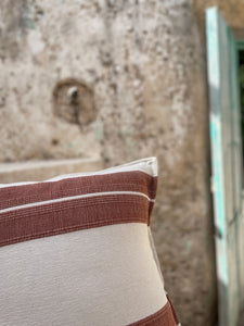 Handmade striped pillow with texture detail.