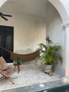 Poolside gold hammock at tulum style villa.