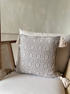 Gray and neutral tassel pillow.