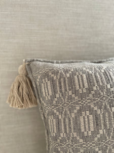 Gray and neutral tassel pillow.